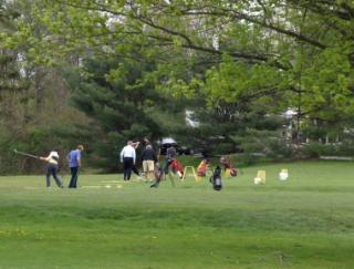 Group of golfers teeing off